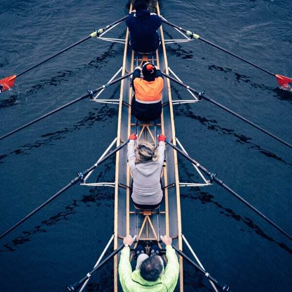 Rowing team training in the water