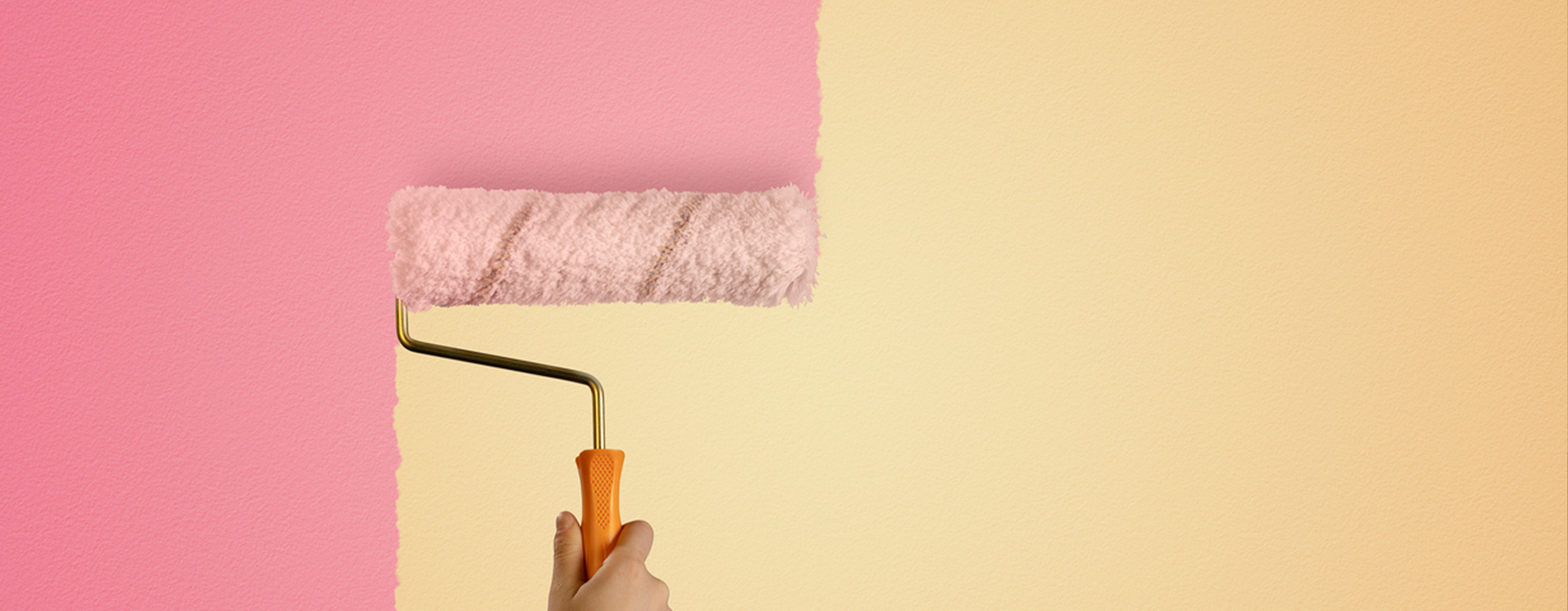 Yellow wall being painted over with pink