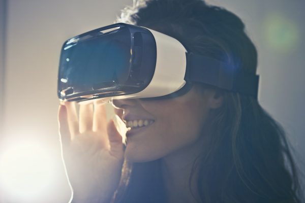 Image of woman wearing virtual reality goggles.