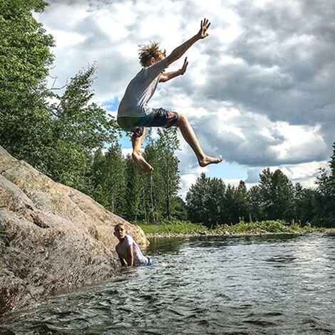 Photo of Johnny Vitorovich's children jumping into a lake on his bio page.