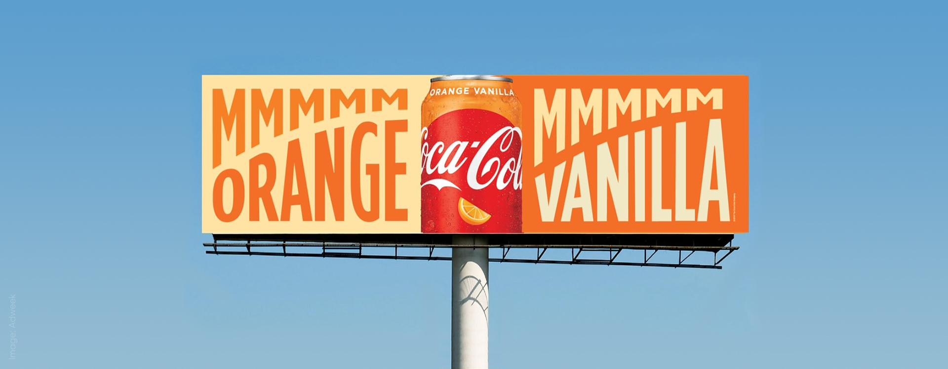 Billboard displaying orange Vanilla Coke advertisement header.