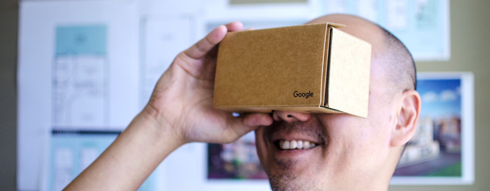 Man holding a box with the google logo to mock VR headsets