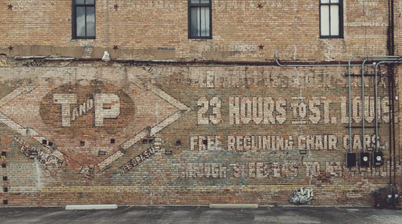 Faded ghost sign hand painted mural in Dallas Texas