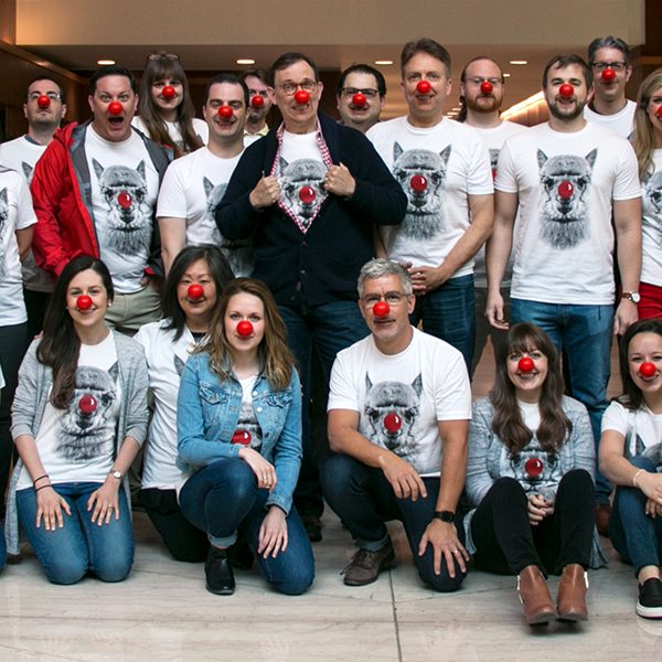 Grafik team wearing lama tshirts with red noses, while the employees were red noses