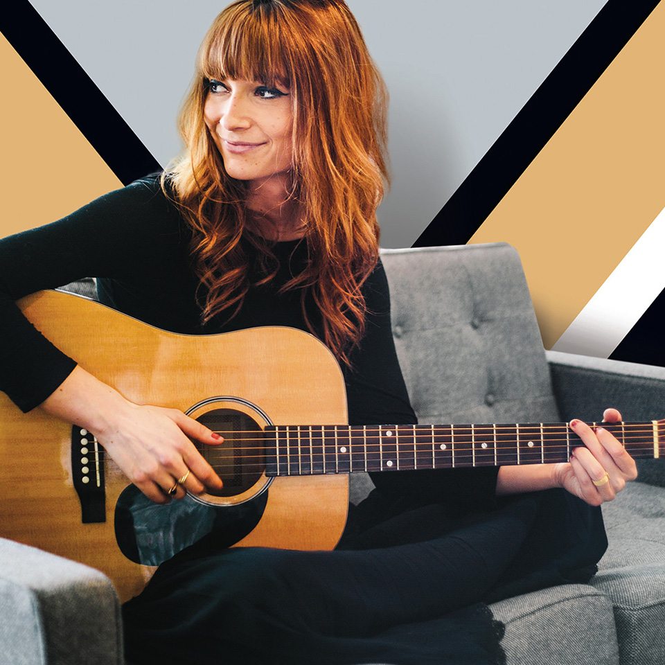 Woman with a guitar embodies Bozzuto's brand identity for their new apartment building branding efforts executed by top branding agency, Grafik.