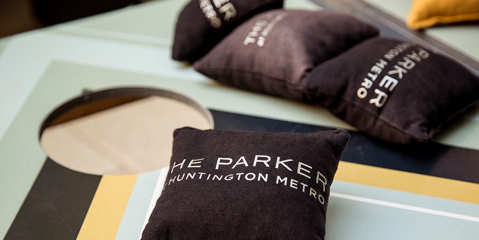 Corn hole bags with The Parker's brand marketing messaging to align with the overall apartment complex brand identity.