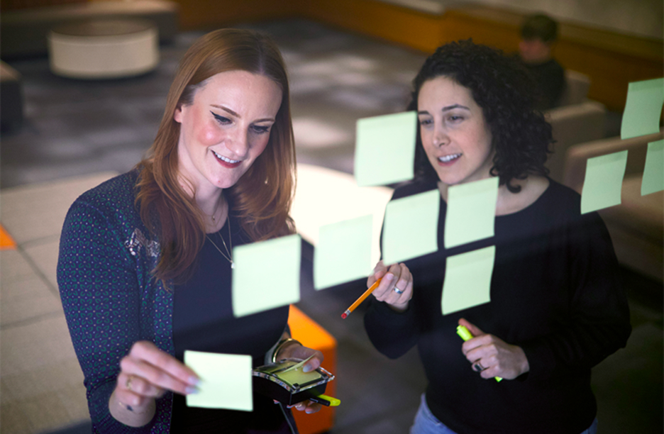 Kathleen and Sara working on a marketing campaign Kathleen and Sara working on a marketing campaign