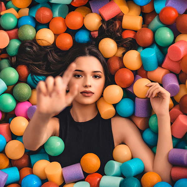 Woman in a lying in a group of colored stress balls