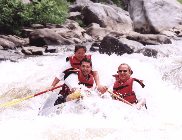 Lynn Umemoto, Principal, rafting with her husband and a friend